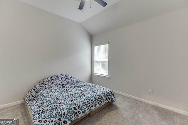 bedroom featuring ceiling fan, carpet floors, and vaulted ceiling