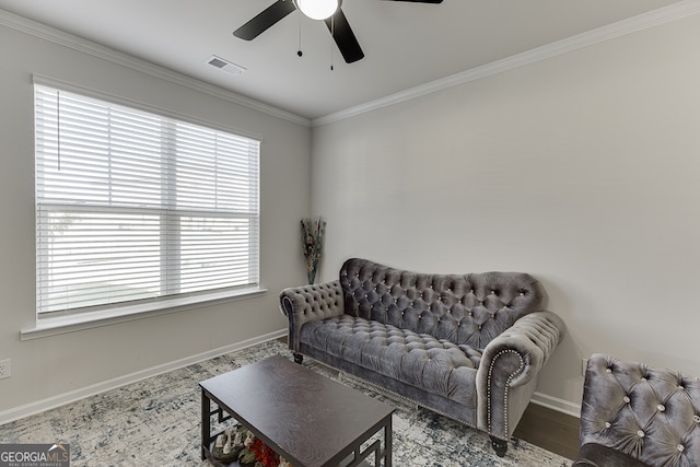 sitting room with crown molding, ceiling fan, and wood-type flooring