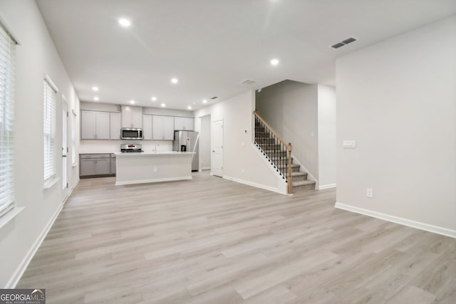 unfurnished living room featuring light hardwood / wood-style flooring