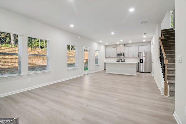 unfurnished living room featuring light hardwood / wood-style floors