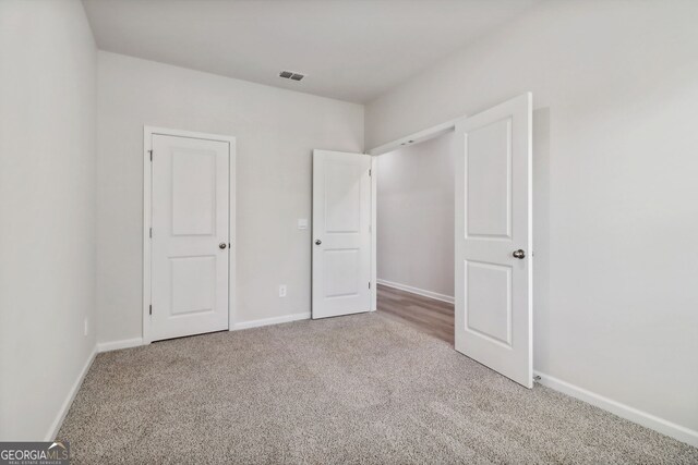 unfurnished bedroom with carpet flooring