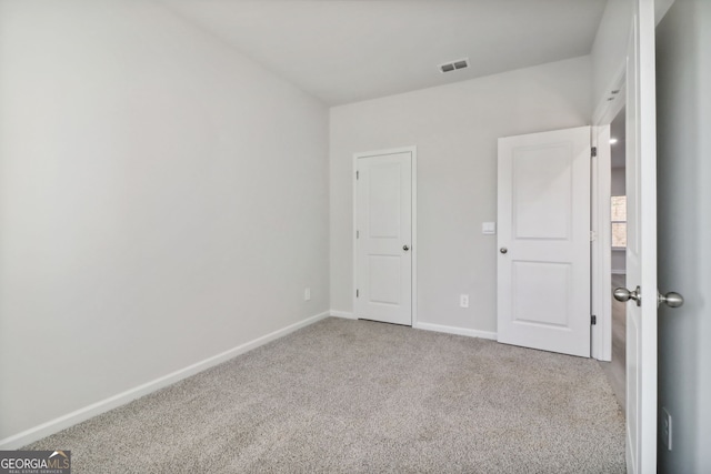 unfurnished bedroom featuring light colored carpet