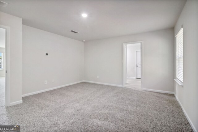 carpeted spare room with a healthy amount of sunlight