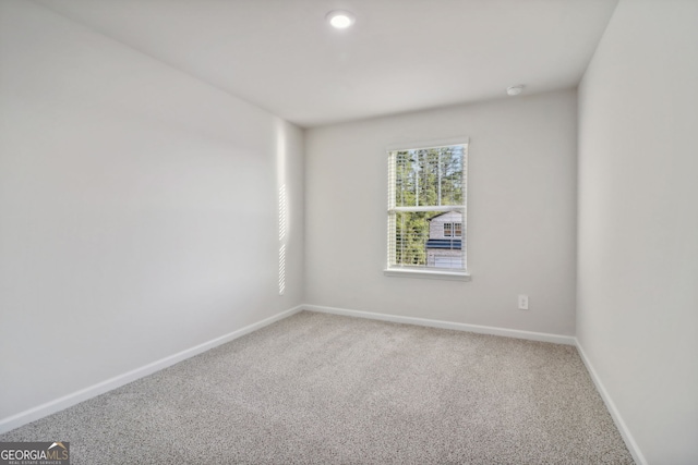 unfurnished room featuring carpet