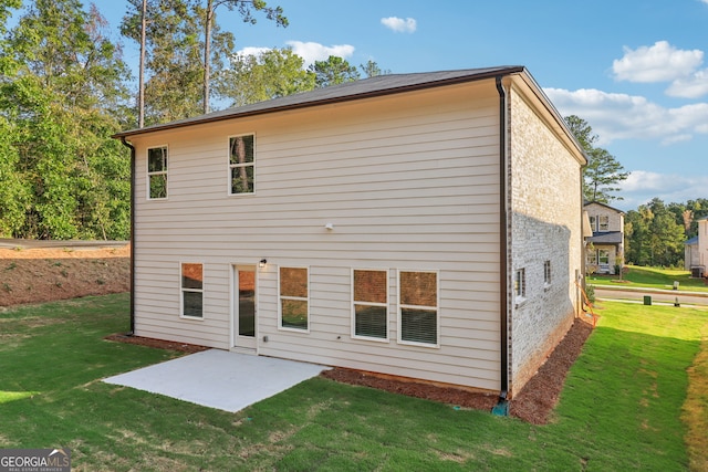 rear view of property with a patio and a yard