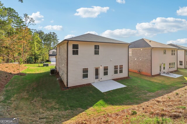 rear view of property with a patio, a yard, and central AC unit