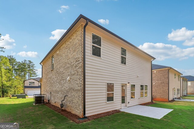 rear view of property with a patio area and a lawn