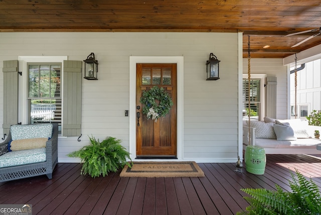 view of exterior entry with covered porch