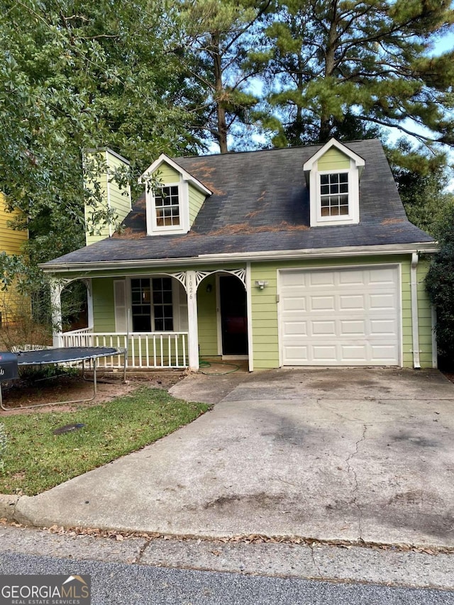 cape cod-style house with a porch and a garage