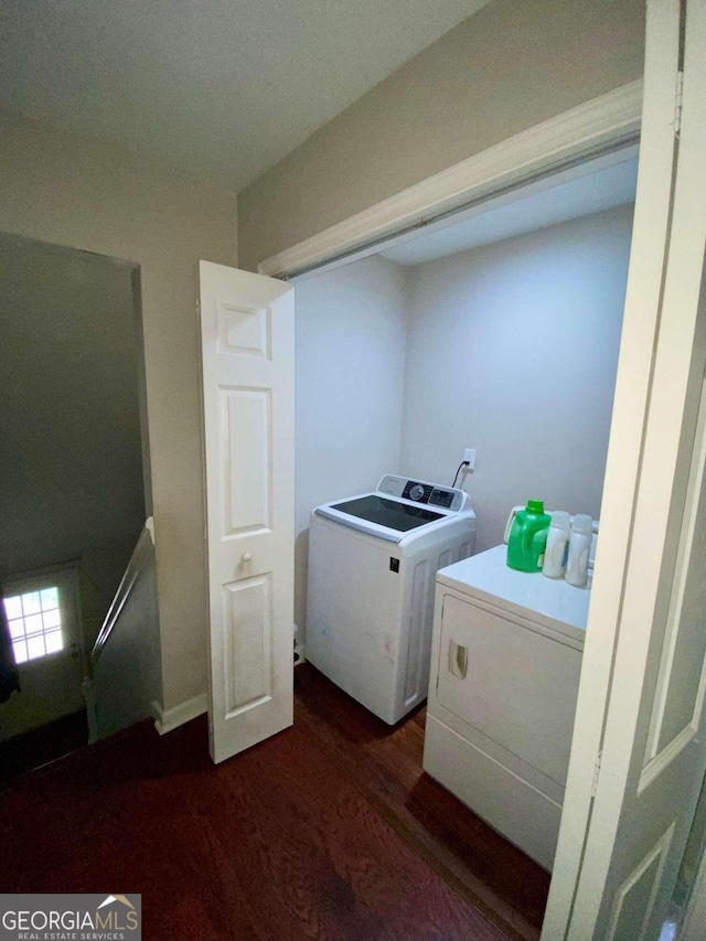 clothes washing area featuring washing machine and dryer and dark wood-type flooring