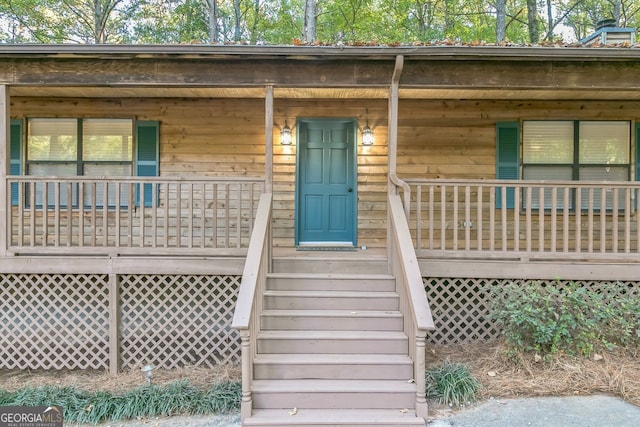 doorway to property featuring covered porch