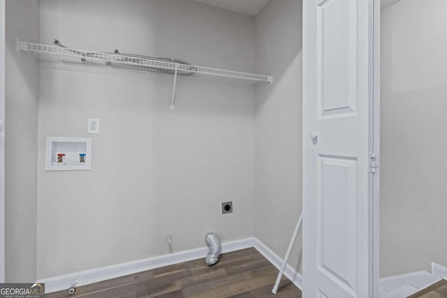 clothes washing area featuring hookup for a washing machine, gas dryer hookup, dark hardwood / wood-style floors, and electric dryer hookup