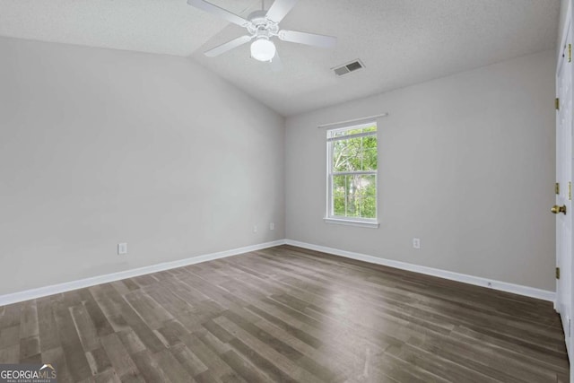 spare room featuring ceiling fan, a textured ceiling, vaulted ceiling, and dark hardwood / wood-style flooring