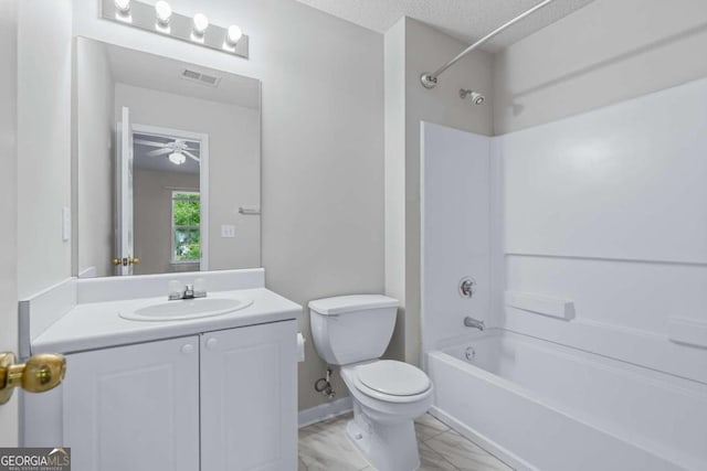 full bathroom with ceiling fan, toilet, bathtub / shower combination, vanity, and a textured ceiling