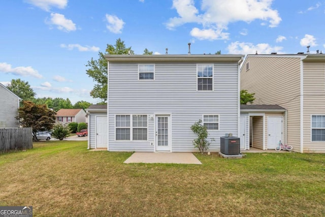 back of property featuring central air condition unit, a lawn, and a patio area