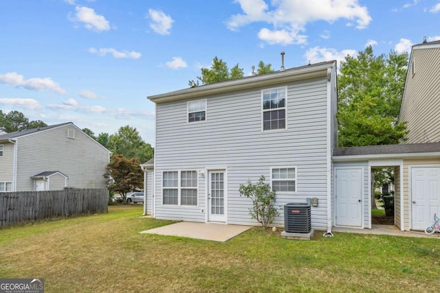 back of property featuring a lawn, a patio, and central air condition unit