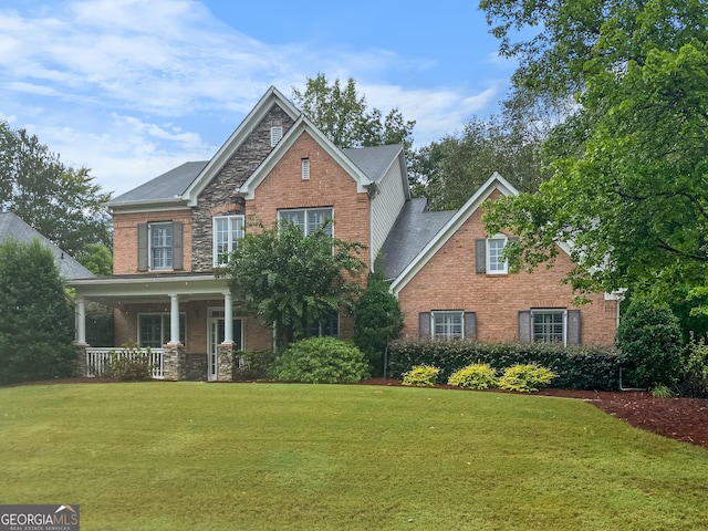 view of front of property with a porch and a front lawn