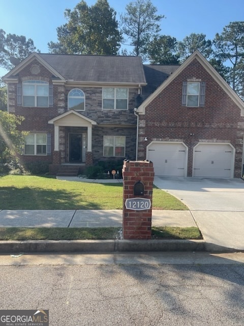 view of front of property with a front lawn and a garage