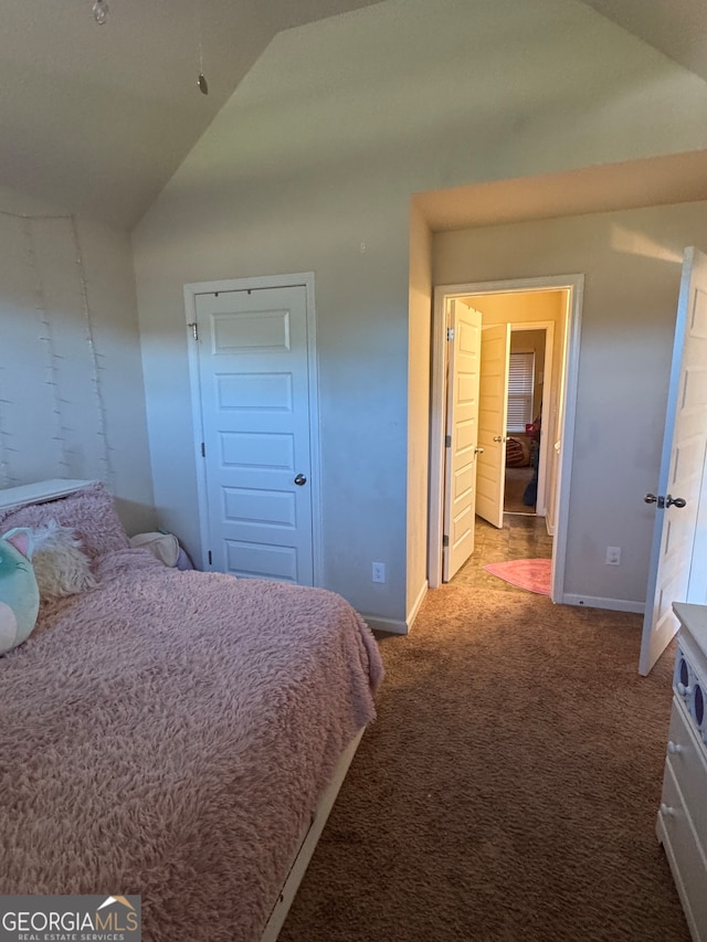 carpeted bedroom featuring vaulted ceiling