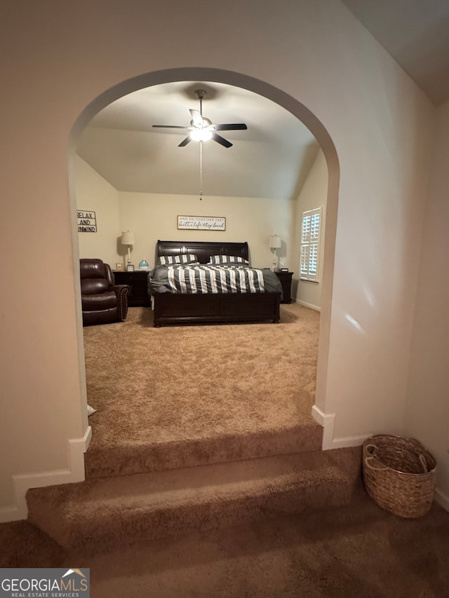 interior space featuring ceiling fan, carpet, and vaulted ceiling