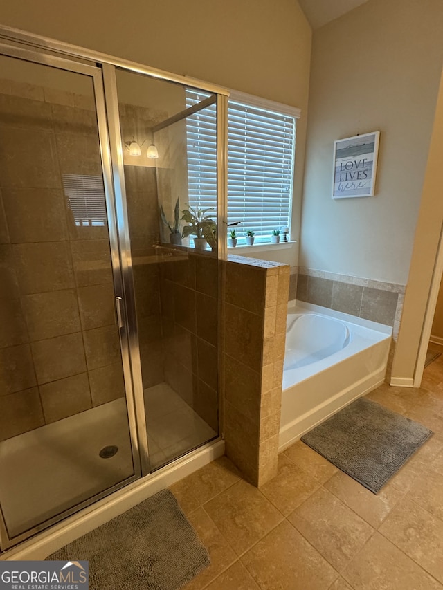 bathroom featuring independent shower and bath and tile patterned flooring