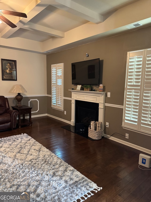 living room with beamed ceiling, ceiling fan, and dark hardwood / wood-style flooring