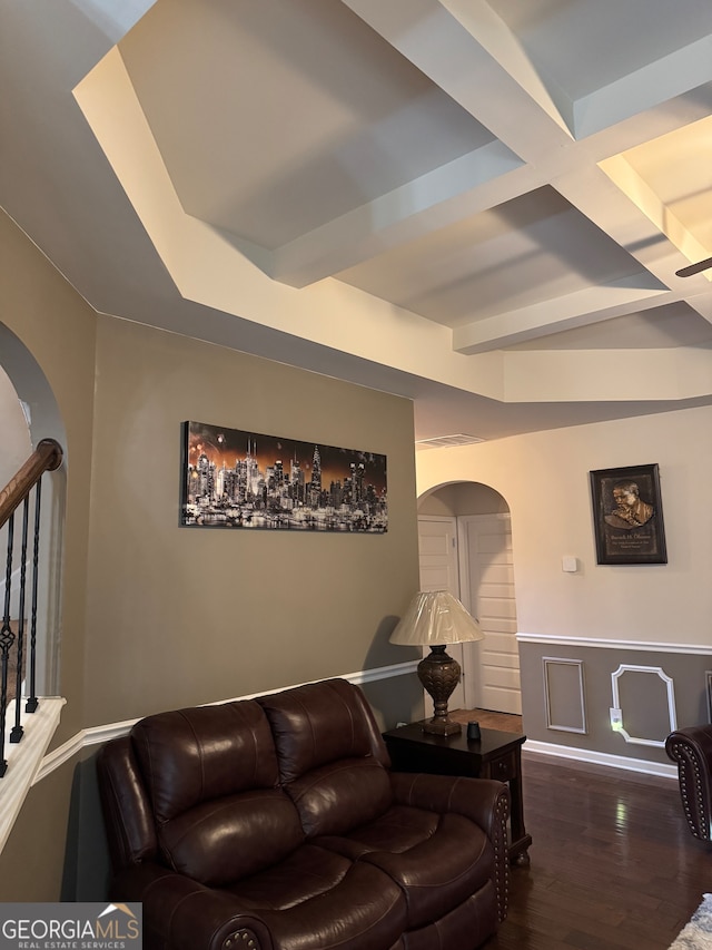 living room featuring beam ceiling and dark hardwood / wood-style floors