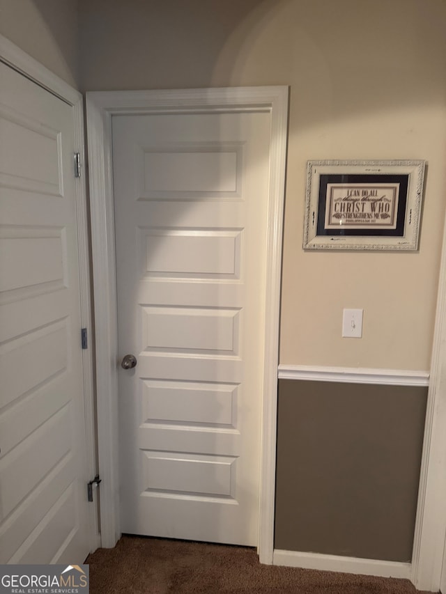 doorway with dark carpet