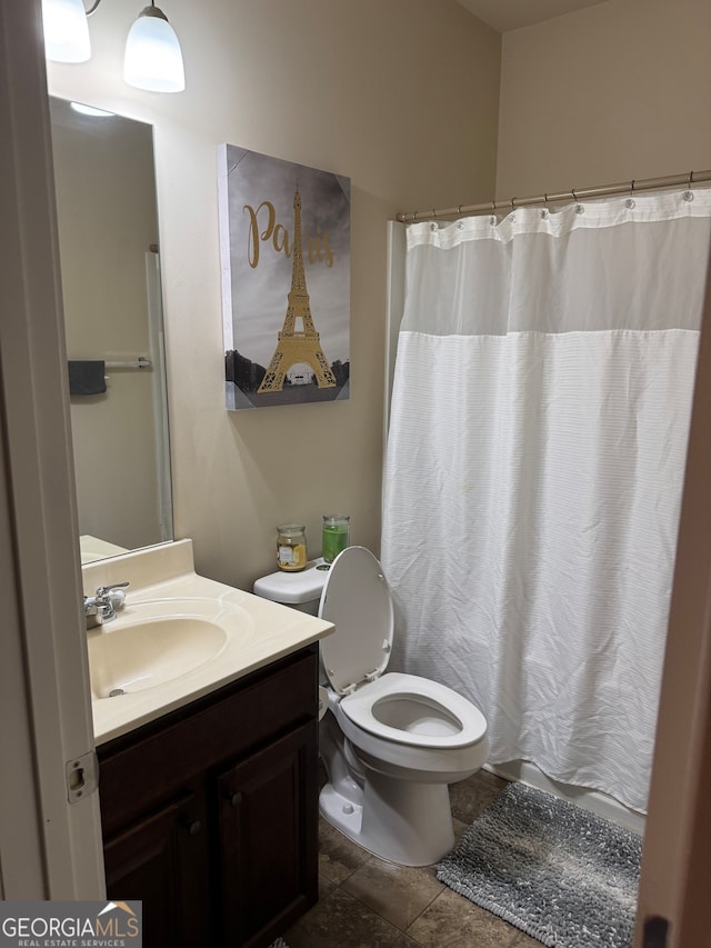 bathroom with vanity, toilet, tile patterned floors, and curtained shower