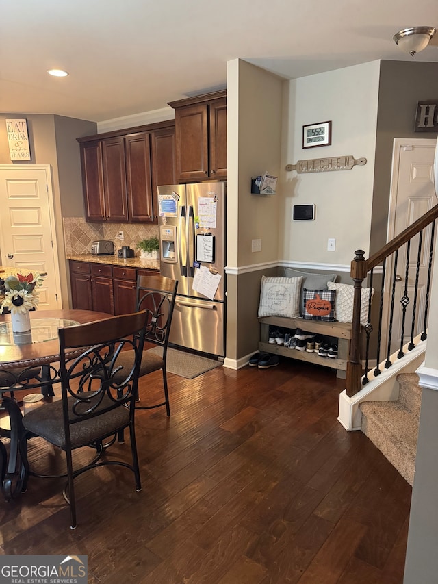 kitchen featuring tasteful backsplash, dark brown cabinetry, wood-type flooring, and stainless steel fridge with ice dispenser