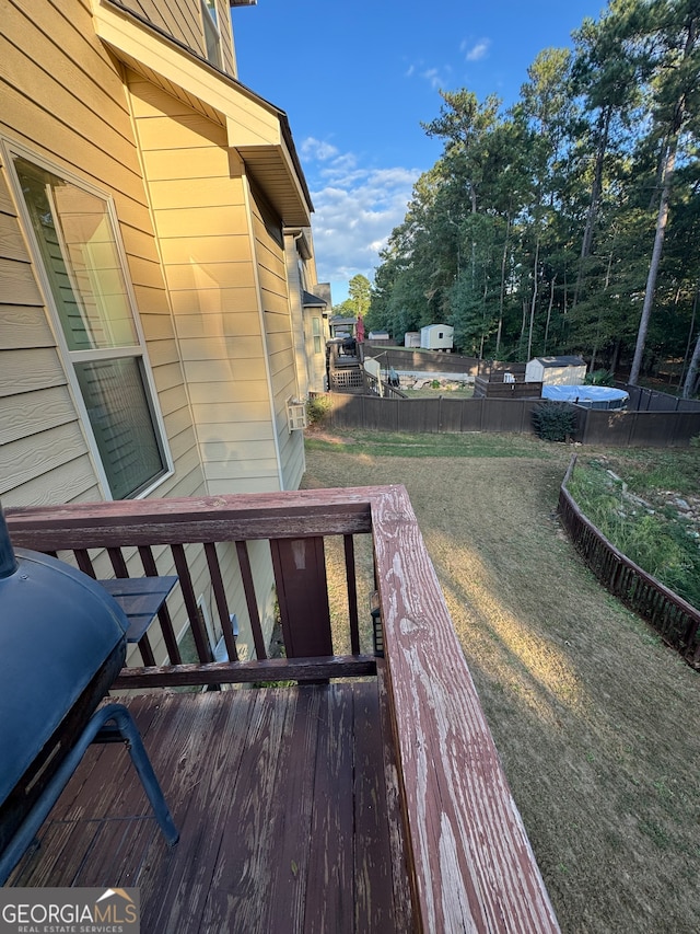 wooden terrace with a lawn