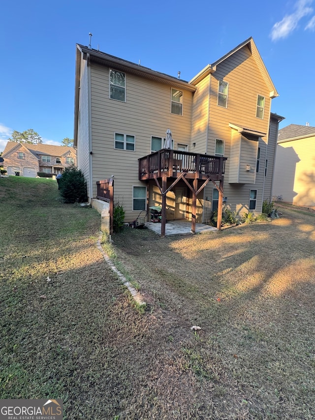 back of house featuring a yard and a wooden deck