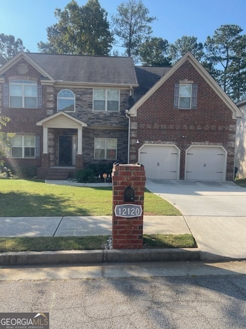 view of front of property with a garage and a front lawn