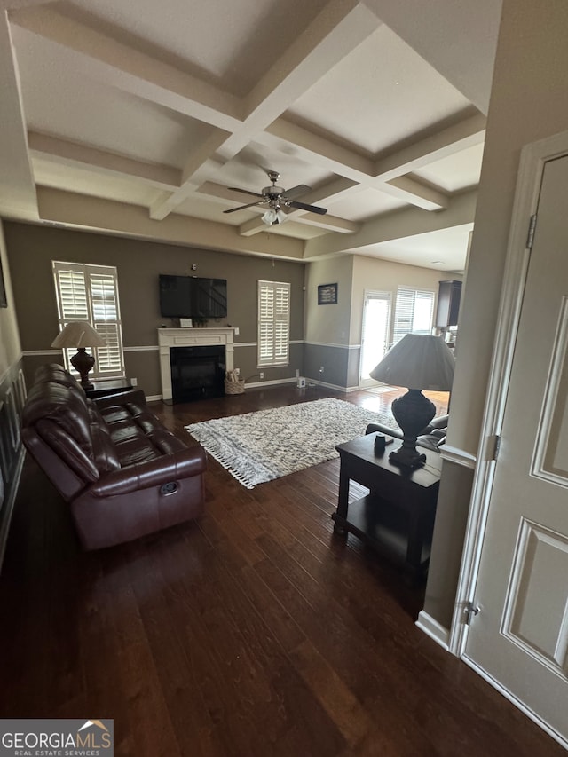 living room featuring hardwood / wood-style floors, beamed ceiling, coffered ceiling, and ceiling fan