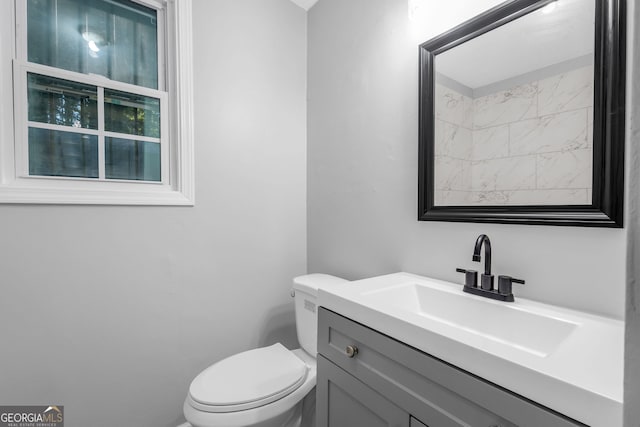 bathroom with toilet and vanity