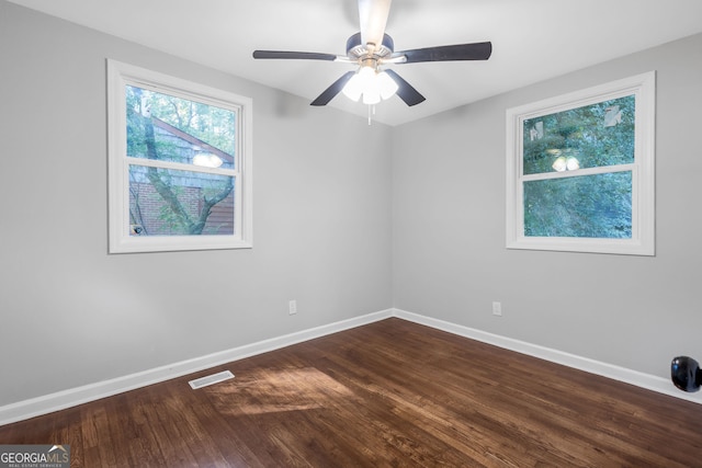 empty room featuring dark hardwood / wood-style flooring and ceiling fan