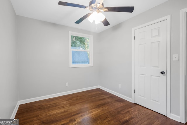 unfurnished room featuring ceiling fan and dark hardwood / wood-style floors