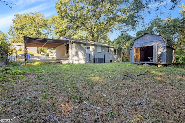 view of yard with a storage shed, a carport, and central air condition unit