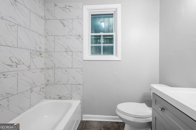 bathroom with vanity, toilet, and a tub