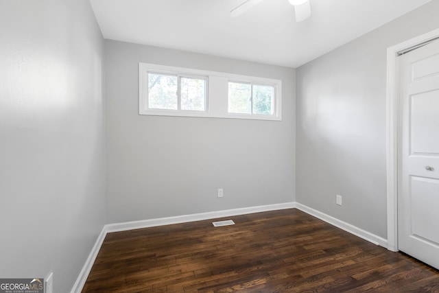 empty room with ceiling fan and dark wood-type flooring