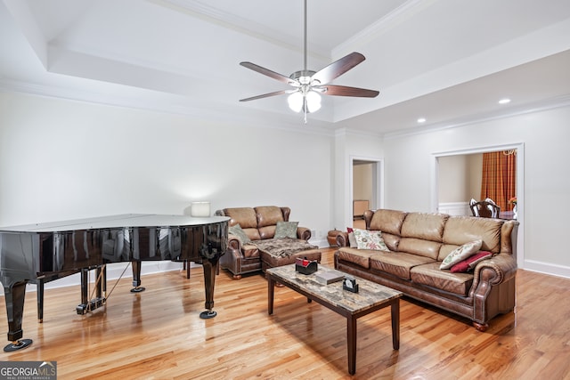 living room featuring crown molding, ceiling fan, and light hardwood / wood-style floors