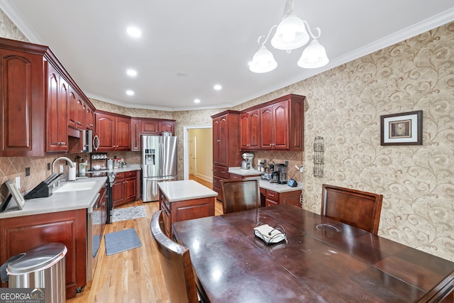 kitchen featuring pendant lighting, stainless steel refrigerator with ice dispenser, crown molding, and a kitchen island