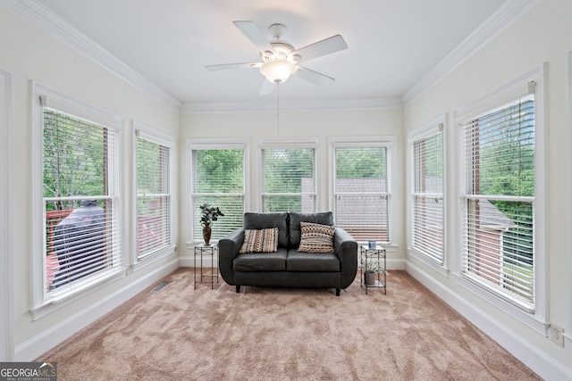 sunroom featuring ceiling fan and plenty of natural light