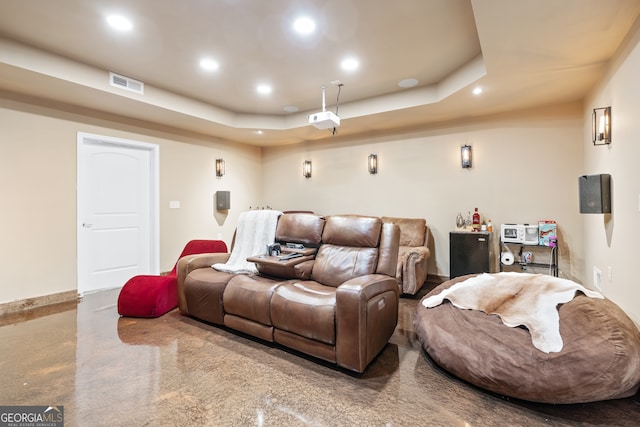 home theater room with a raised ceiling