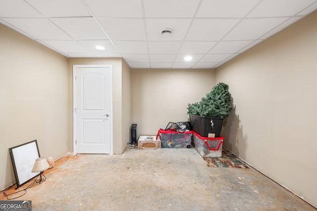 basement with a paneled ceiling