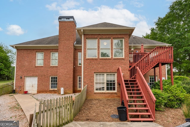 back of house with a wooden deck