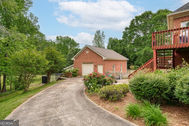 view of side of property with a garage and a deck