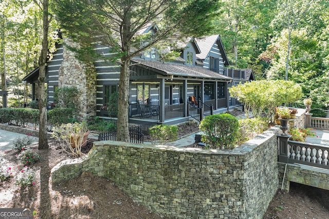 rear view of house with a sunroom