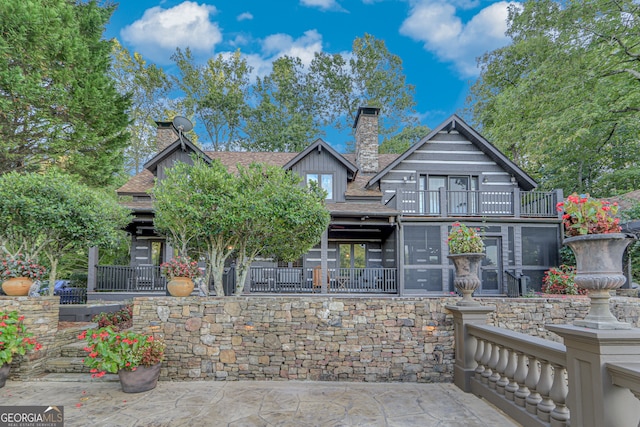 rear view of property with a balcony