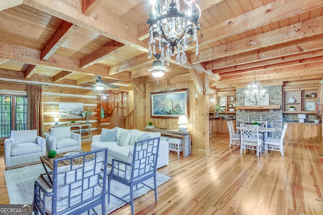 living room with beamed ceiling, wooden walls, wood ceiling, and light hardwood / wood-style floors